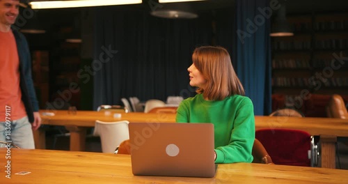 Young successful students collaborating on university project in library giving high five