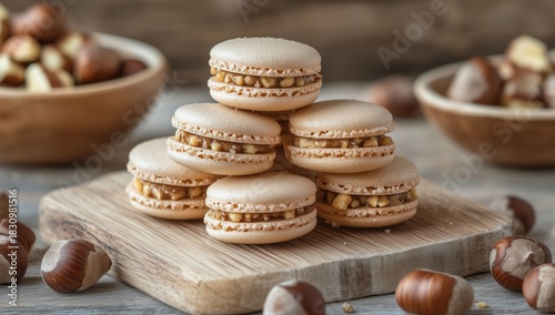 Delicious Homemade Macarons Stacked on a Wooden Board With Nuts in the Background
