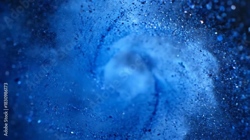 Swirling deep blue abstract art with bokeh, resembling a vortex or galaxy