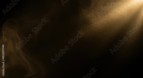 Golden light shining through smoke or dust particles on black background