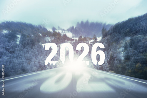 Empty road with faded blurred numbers of past years on the asphalt leading toward a glowing 2026 on the horizon. Leaving the old years behind and moving forward into the new year.