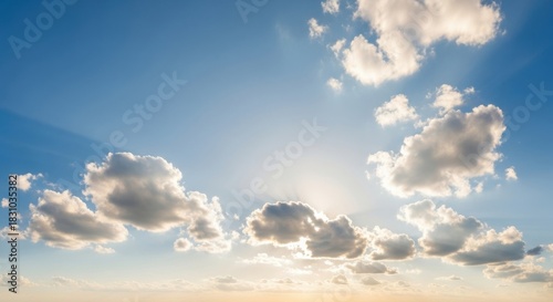 Sunbeams breaking through clouds in blue sky