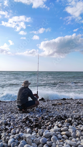 Man Fishing on Rocky Coast of Étretat, France