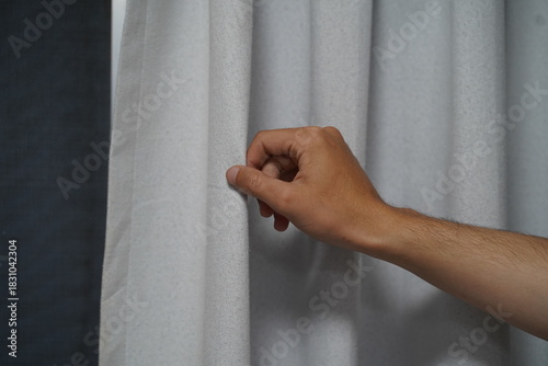 Hand Interacting with Soft White Curtain Fabric, Close-up View of Delicate Texture and Subtle Light Play, Home Decor Inspiration for Interior Design