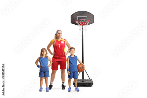 Female basketball coach posing with a group of kids