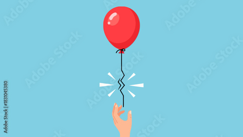 Red balloon with broken string above a hand