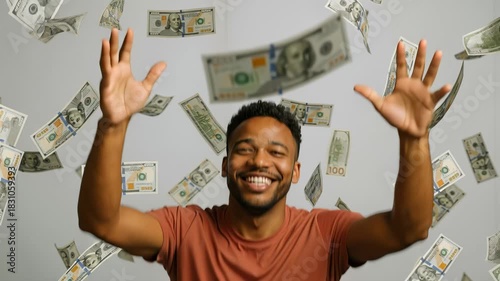 Overjoyed black man shouts with happiness as hundred-dollar bills rain down. Sudden wealth and jackpot winner. Static medium shot.