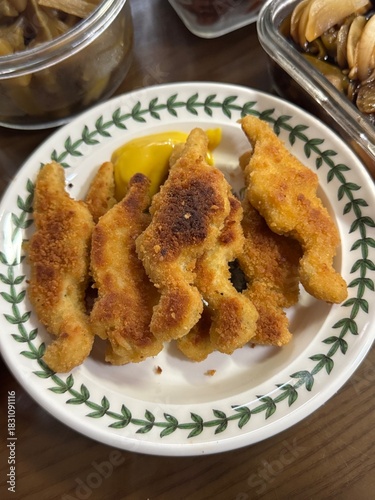 Korean Chicken Nuggets Served with Mustard Sauce on a Plate