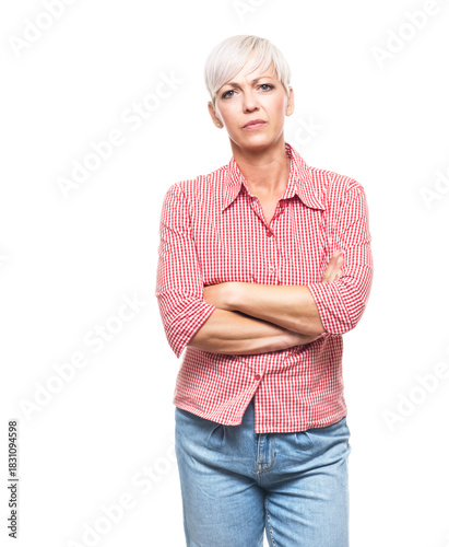 Portrait of serious adult woman, strict middle aged woman with hands on waist looking to camera, isolated on white background.
