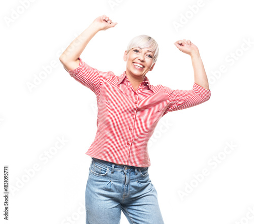 Excited adult woman at winner, isolated on white background. Yes concept. Good news. Copy space. Pretty middle aged woman celebrates success.