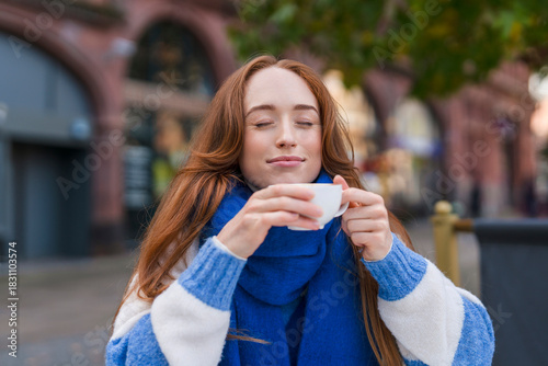 Enjoying a warm cup of coffee in a cozy outdoor setting on a cool afternoon