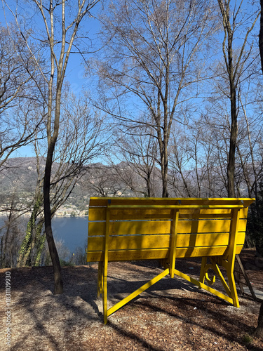 Giant yellow bench on a hill over Lake Garda, Italy
