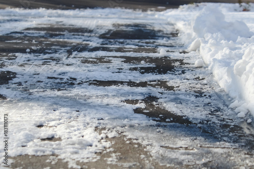 close-up of a plowed driveway or concrete surface with copy space. winter holiday or season background. Winterdienst backdrop. transportation or infrastructure.