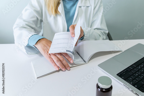 Female doctor writing prescriptions in medical office