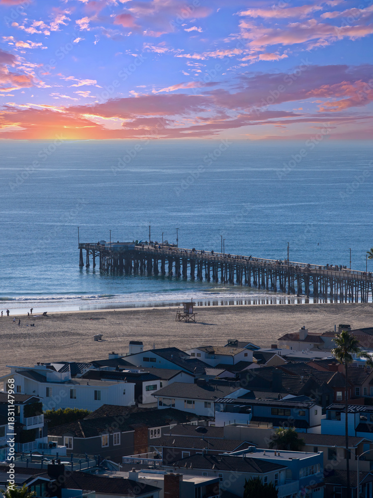 Fototapeta premium Aerial shot along the coastline at the Newport Beach Pier in Newport Beach California USA