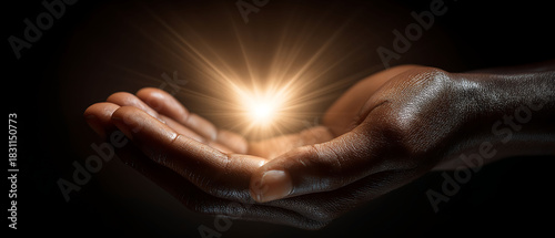 Heart-shaped light glow held between hands on Random Acts of Kindness Day