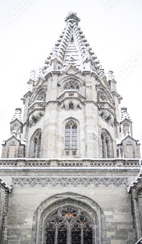 A glance upward at the gentle snowfall above the winter-covered steeple of the “Müntzer unserer lieben Frau” (Church of Our Lady). Constance, Baden Württemberg, Germany.