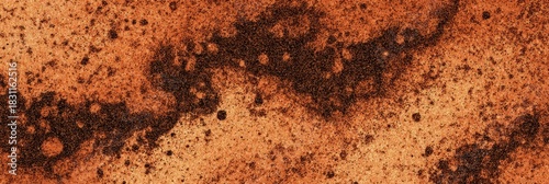 Scattered cinnamon powder forms abstract patterns on a warm surface with fine speckles and rich reddish-brown tones in a textured close-up
