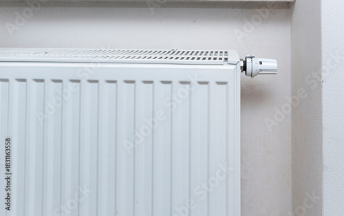 Wallpaper Mural White radiator installed in a modern home providing heat during winter. Its design integrates seamlessly into the room's decor, ensuring comfort and warmth. Torontodigital.ca