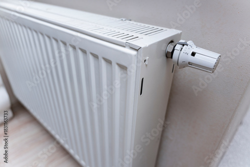 Wallpaper Mural Close-up of a modern white radiator installed in an indoor setting. The image shows the heating control valve, emphasizing home heating and comfort. Torontodigital.ca