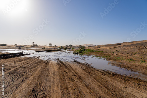 The rain water left on the ground in the Sahara Desert after a rare rainfall event in Morocco. In late summer 2024, the Sahara Desert experienced an unusual and significant rainfall event. 