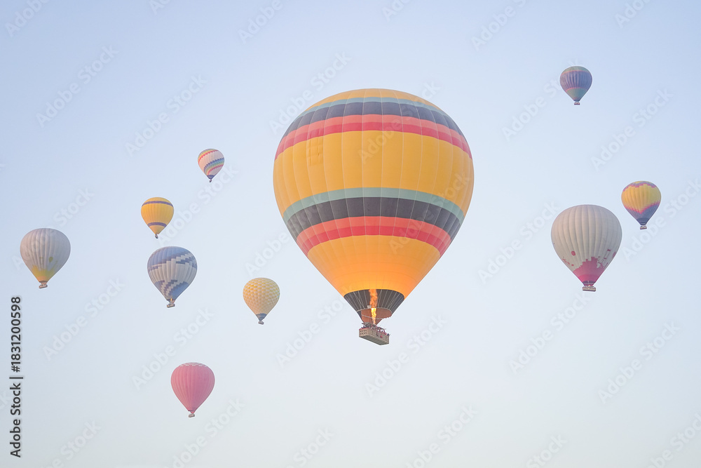 Fototapeta premium Hot Air Balloons over Cappadocia Valleys in Nevsehir, Turkiye