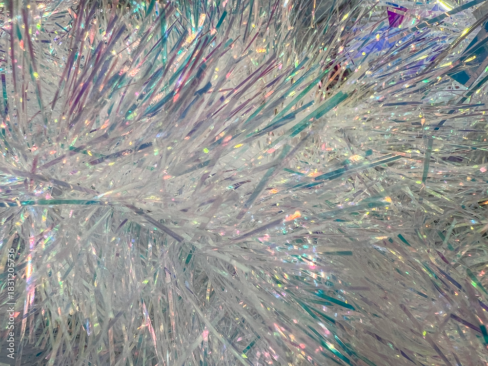 Obraz premium Glittering iridescent tinsel close-up with sparkling light reflection