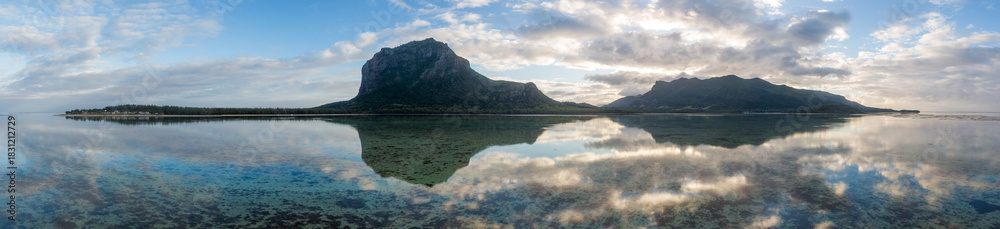 Obraz premium Panoramic view of Le Morne Bay and Le Morne Mountain at sunrise, Mauritius