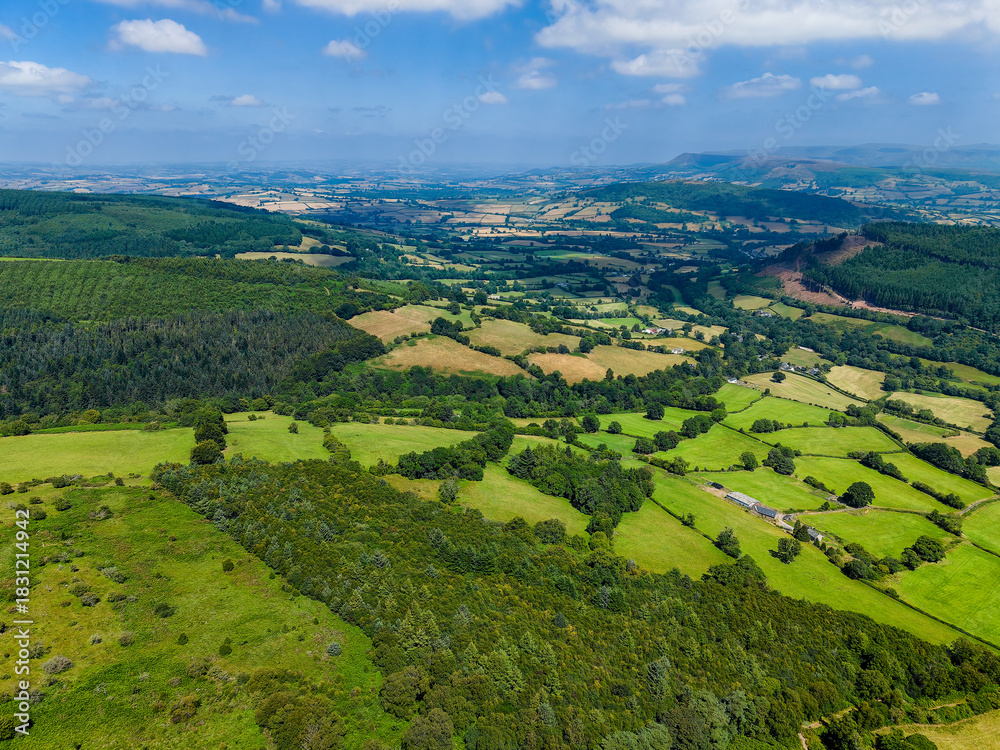 Fototapeta premium Scenic summer landscape showing green fields, forests, and farms in rural Wales, UK