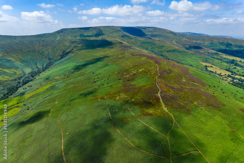 Fototapeta premium Vast green and purple hillsides under a blue summer sky in the Welsh mountains.