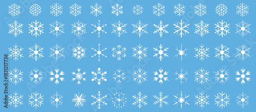 Delicate snowflakes falling gently on light blue background create a magical winter wonderland, perfect for holiday designs