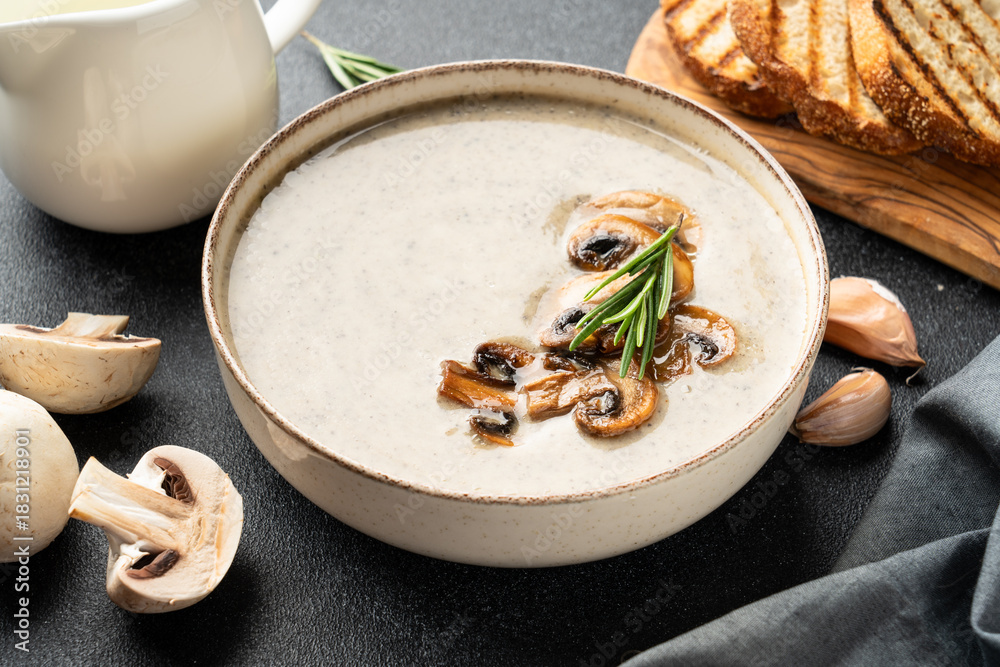 Naklejka premium Mushroom soup puree on white kitchen table.