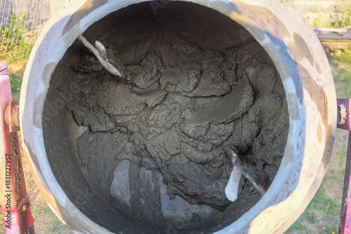 Concrete mixer in blurry motion mixes cement-sand masonry mortar