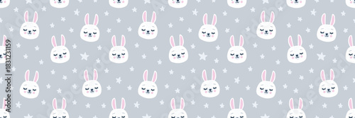 Cute seamless pattern with white bunny faces on a grey background. Adorable hand-drawn rabbits with pink cheeks, surrounded by stars. Perfect for kids textiles, nursery decor and wrapping paper