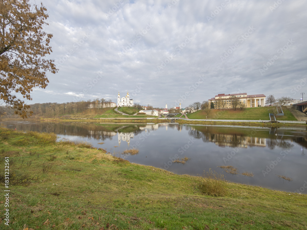 Fototapeta premium Peaceful scene of a river with a town in the background