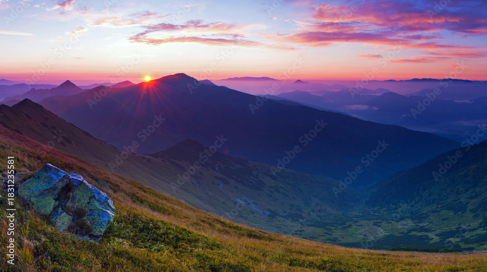 Fototapeta premium Breathtaking sunrise over rugged mountain peaks.