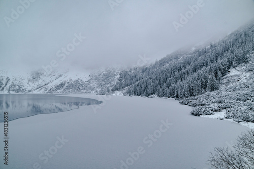 Fototapeta Naklejka Na Ścianę i Meble -  Morskie Oko Lake Covered in Ice at Winter in Tatra Mountains Poland.