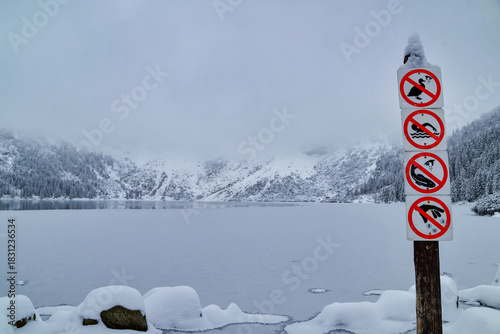 Fototapeta Naklejka Na Ścianę i Meble -  Morskie Oko Lake Covered in Ice at Winter in Tatra Mountains Poland.