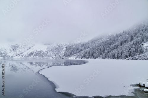 Fototapeta Naklejka Na Ścianę i Meble -  Morskie Oko Lake Covered in Ice at Winter in Tatra Mountains Poland.