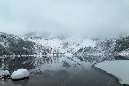 Fototapeta Naklejka Na Ścianę i Meble -  Morskie Oko Lake Covered in Ice at Winter in Tatra Mountains Poland.