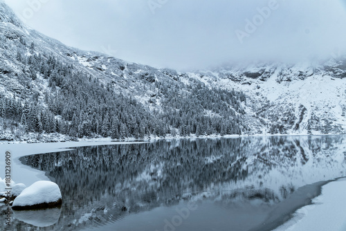 Fototapeta Naklejka Na Ścianę i Meble -  Morskie Oko Lake Covered in Ice at Winter in Tatra Mountains Poland.