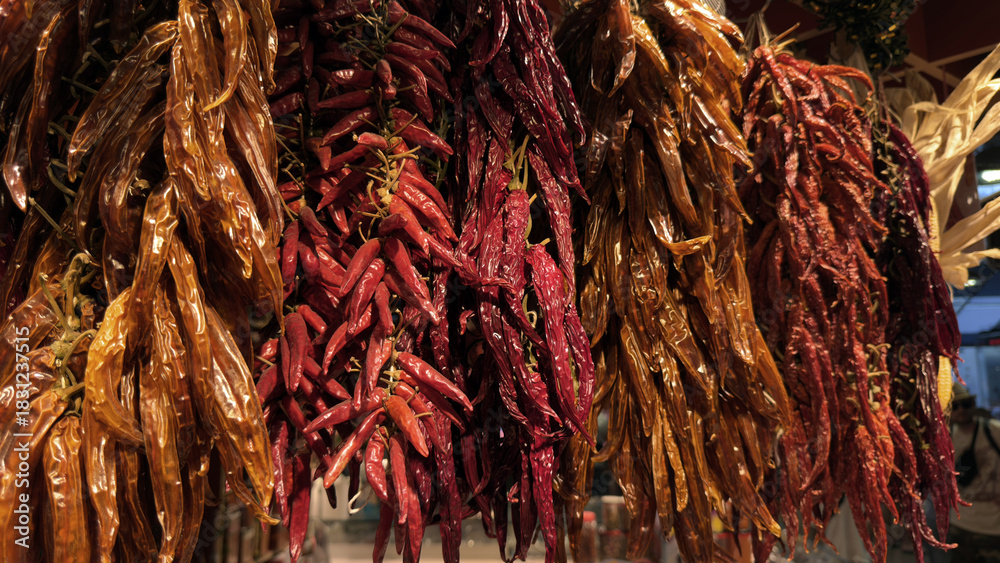 Fototapeta premium Dried Chili Peppers Hanging at a Market Stall