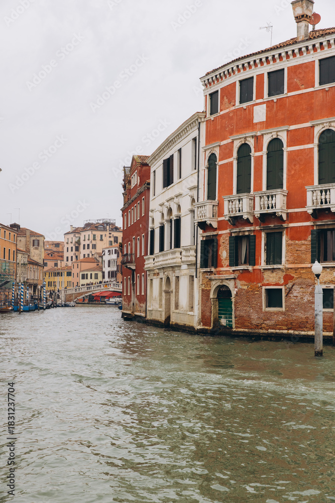 Fototapeta premium Venice canal with historical buildings and arched bridge