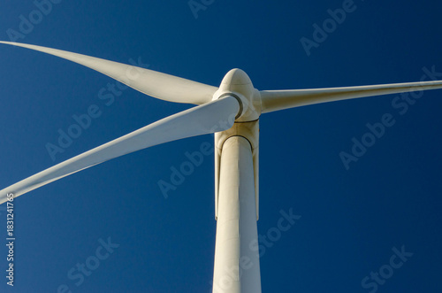 Close up white wind turbine blades clean energy engineering design copy space.