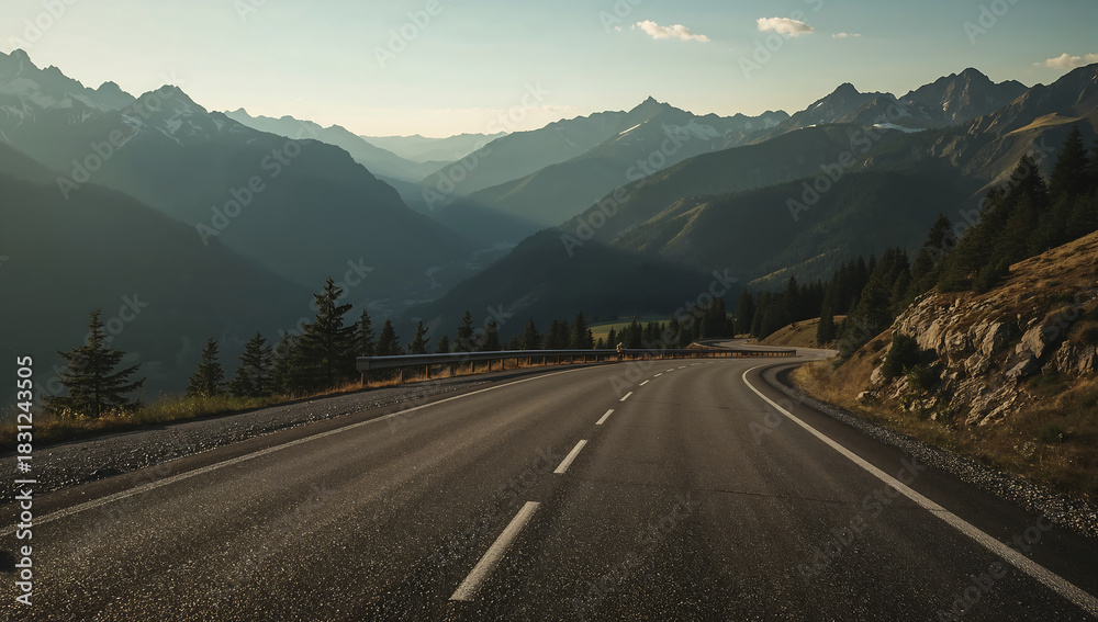 Naklejka premium Winding Road Through Mountain Pass at Sunset
