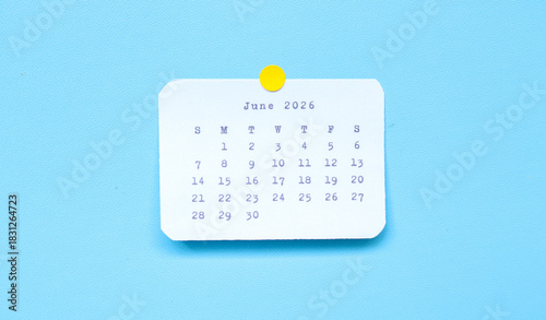 Photos A paper sticker showing June 2026 placed on a blue background