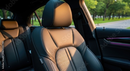 Close-up of luxurious black leather car seats bathed in warm sunlight, highlighting comfort and premium interior design