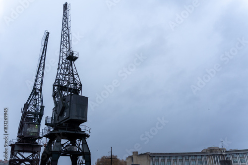 Cranes against a cloudy sky