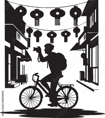 Silhouette of tourist photographer on bicycle under chinese lantern street