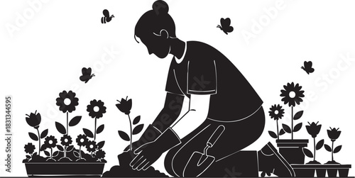 Silhouette of woman kneeling while planting flower in garden